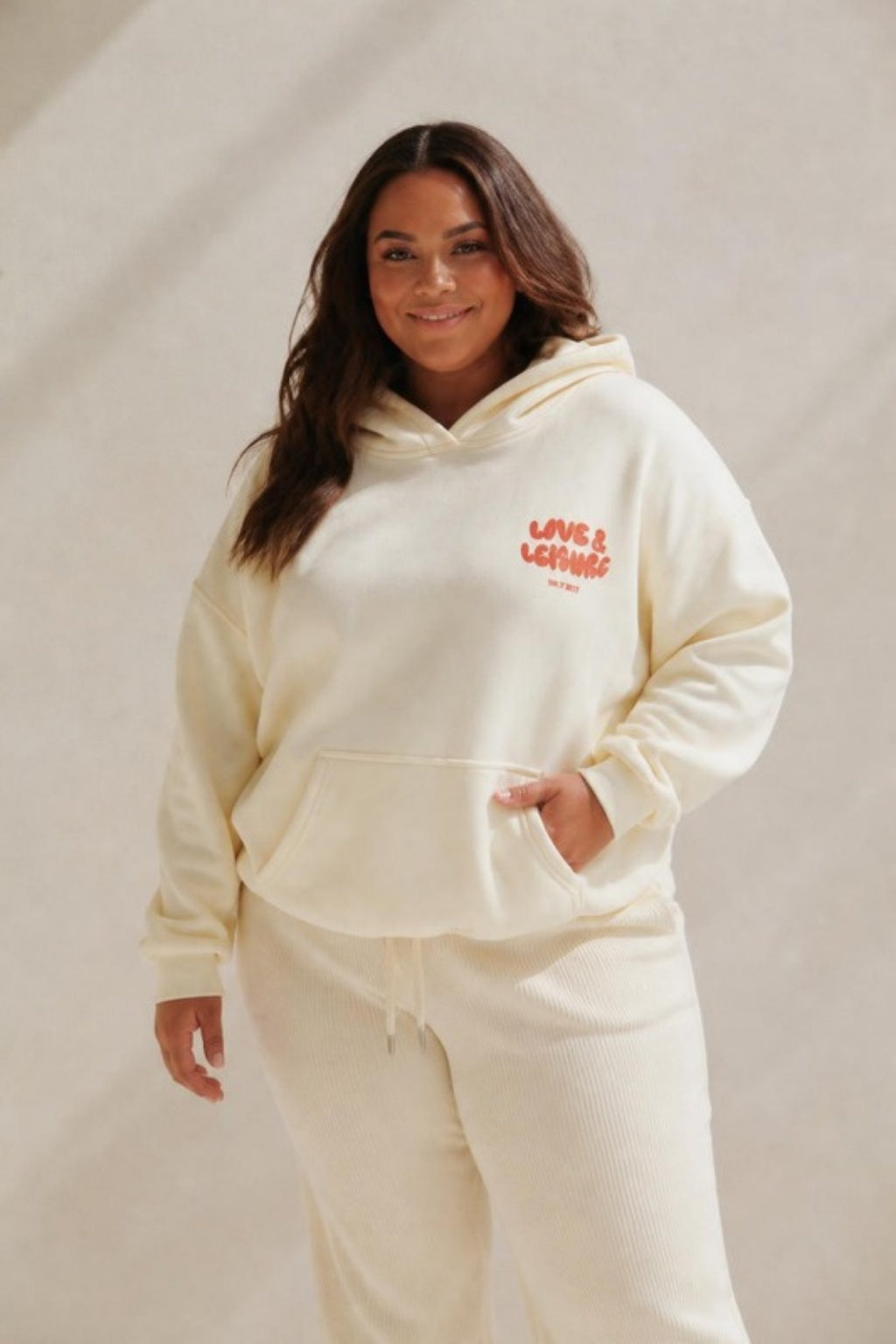 Size 3XL model wearing Love &amp; Leisure Adults Hoodie - Cherry Cream