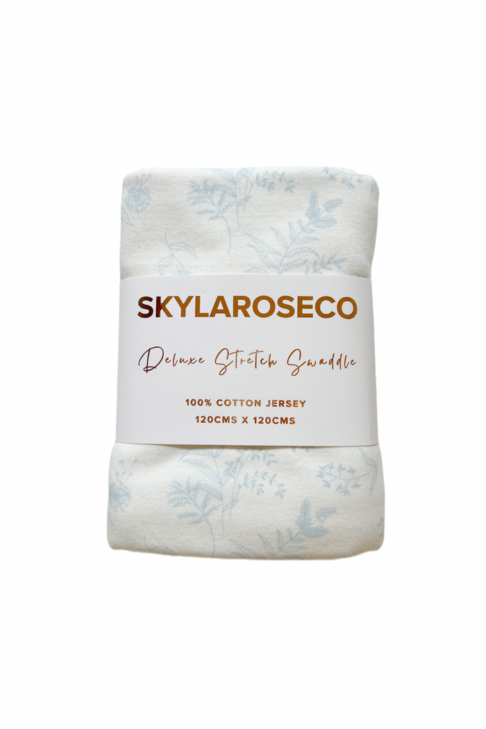 Swaddle folded in its branded packaging. Deluxe Stretch Swaddle in Forrest by Skylaroseco