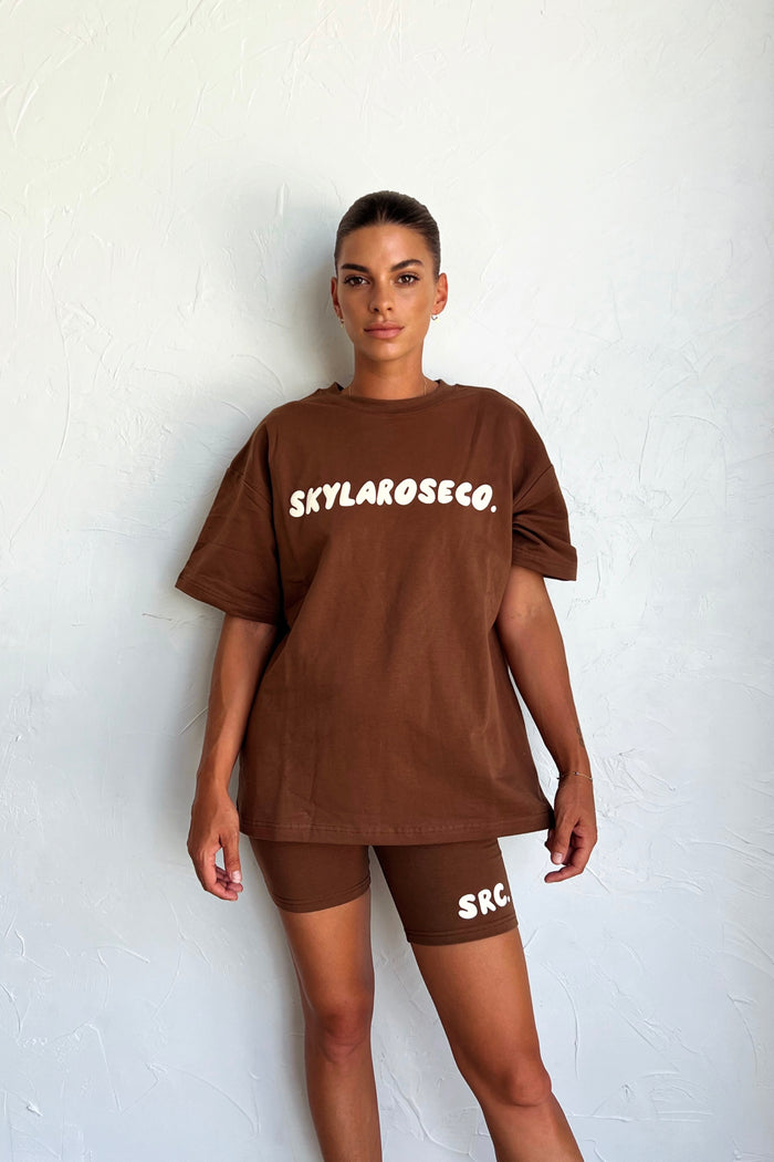 Woman wearing the bike shorts with a matching chocolate oversized tee. Summer Club Adults Bike Shorts in Chocolate by Skylaroseco
