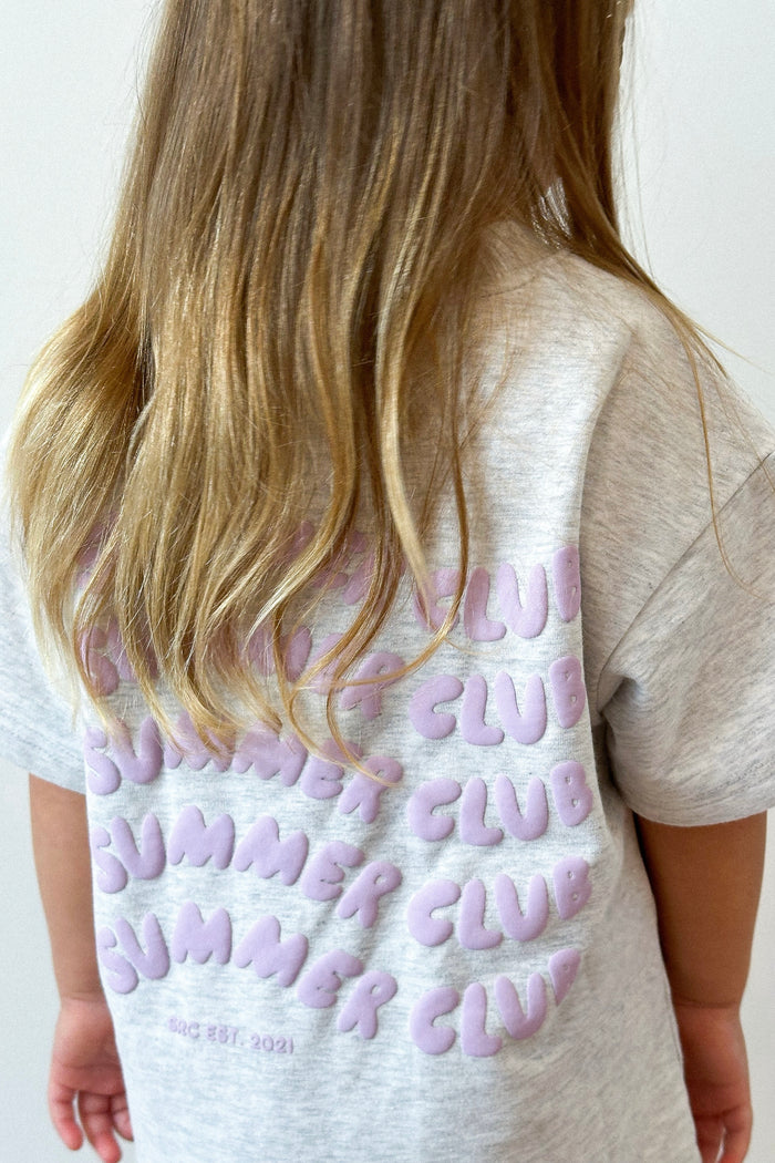 Back view of a girl wearing the tee, showing the lilac puff print logos. Summer Club Kids Set in Grey Marle by Skylaroseco