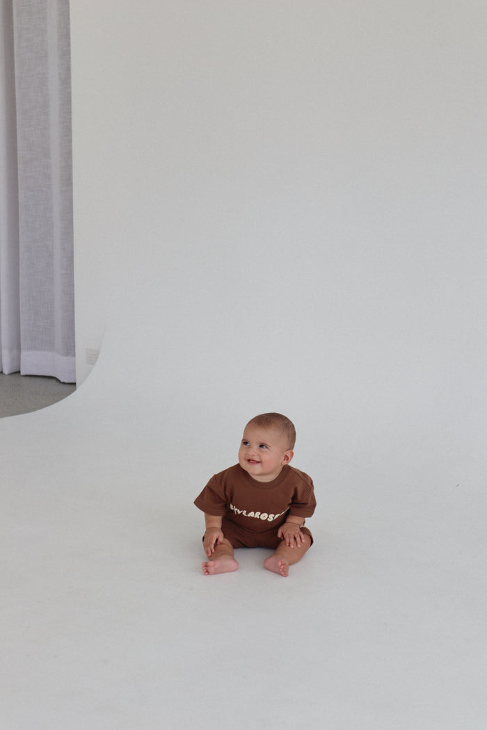 Baby sitting in the chocolate set in a white studio. Summer Club Kids Set in Chocolate by Skylaroseco