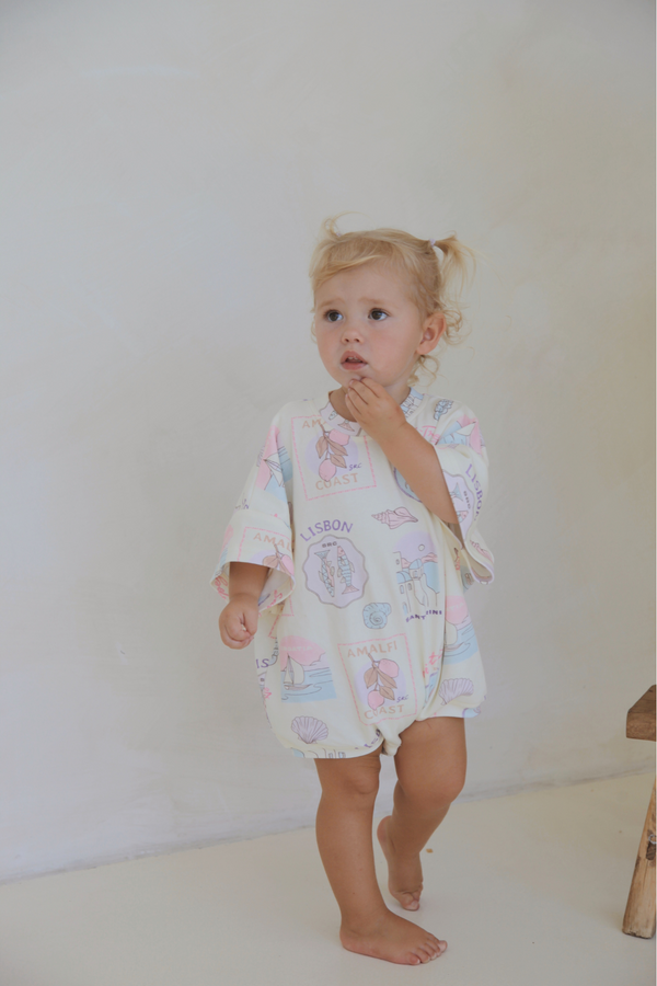 Toddler standing in the Euro Summer romper. Oversized Tee Romper in Euro Summer print by Skylaroseco