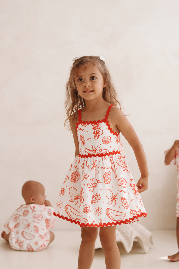 Girl standing in the Solenne Linen Dress in Coastline print by Skylaroseco - try-on