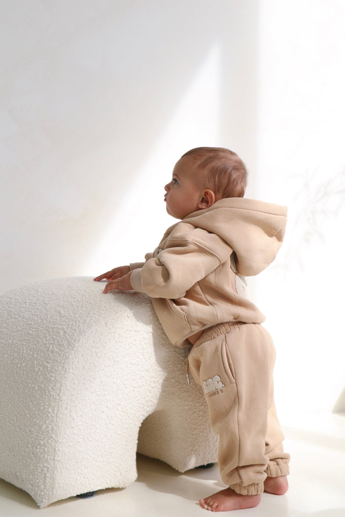 Toddler leaning on a boucle stool in the latte lounge set. Cosy Club 2.0 Kids Lounge Set in Latte by Skylaroseco