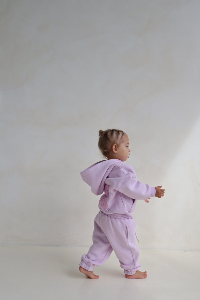Toddler walking in the lilac hoodie and sweatpants set. Cosy Club 2.0 Kids Lounge Set in Lilac by Skylaroseco